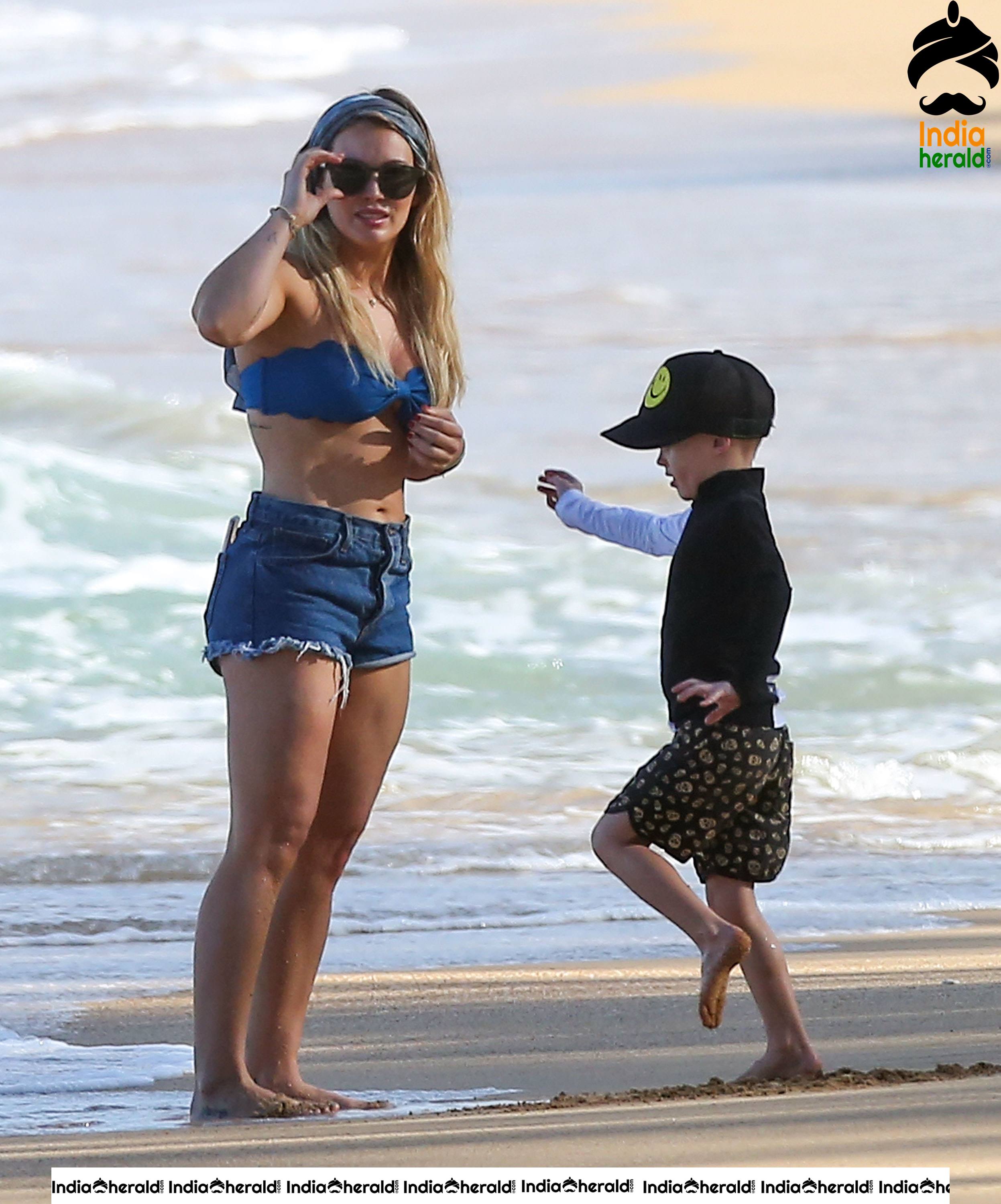 Hilary Duff Wearing a bikini top and shorts at the beach in Hawaii Set 1
