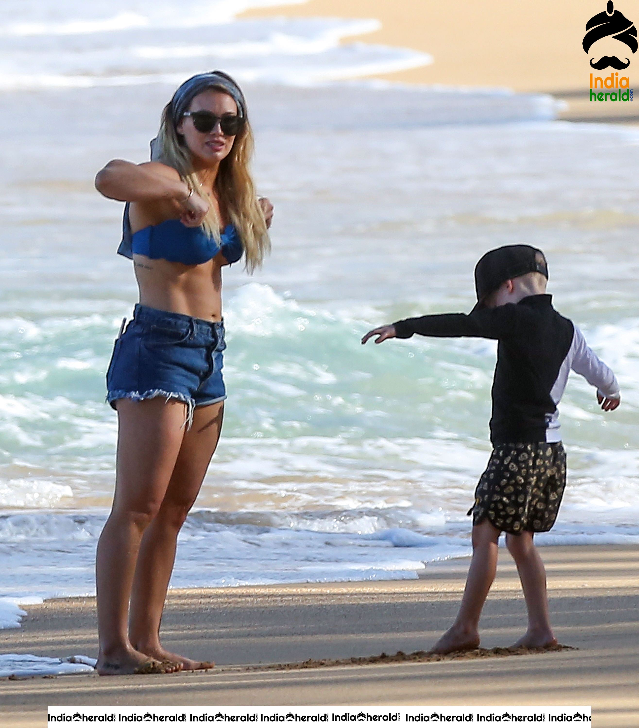 Hilary Duff Wearing a bikini top and shorts at the beach in Hawaii Set 1