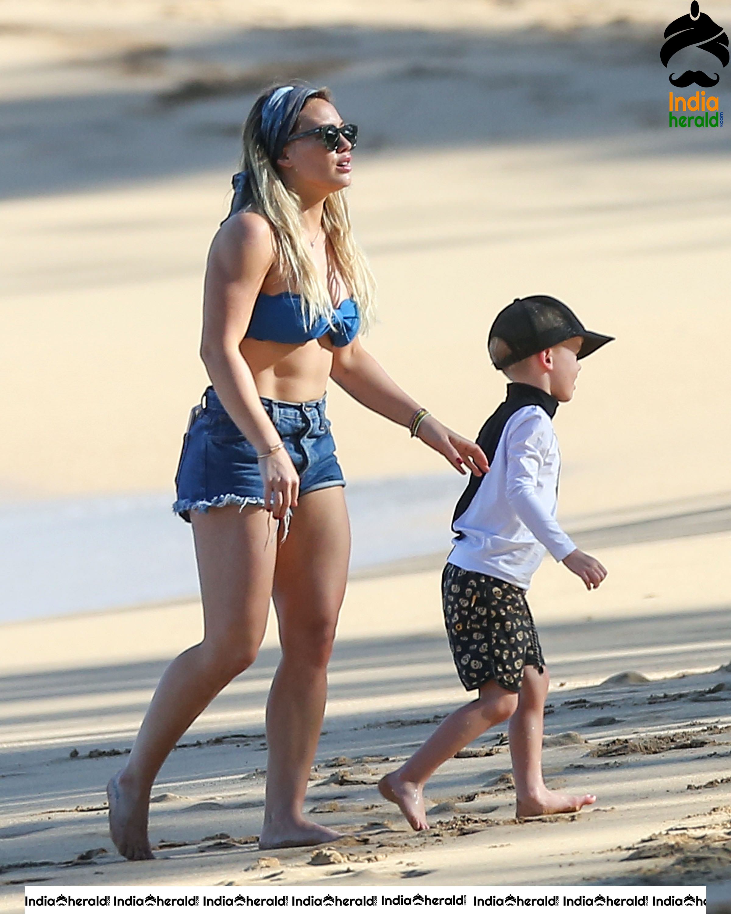Hilary Duff Wearing a bikini top and shorts at the beach in Hawaii Set 2