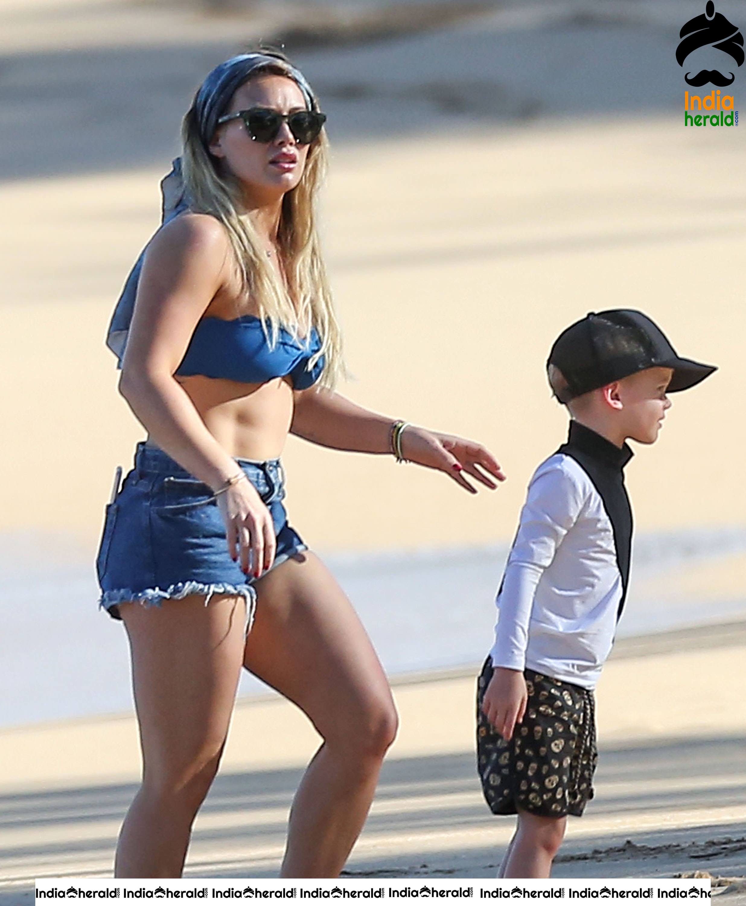 Hilary Duff Wearing a bikini top and shorts at the beach in Hawaii Set 2