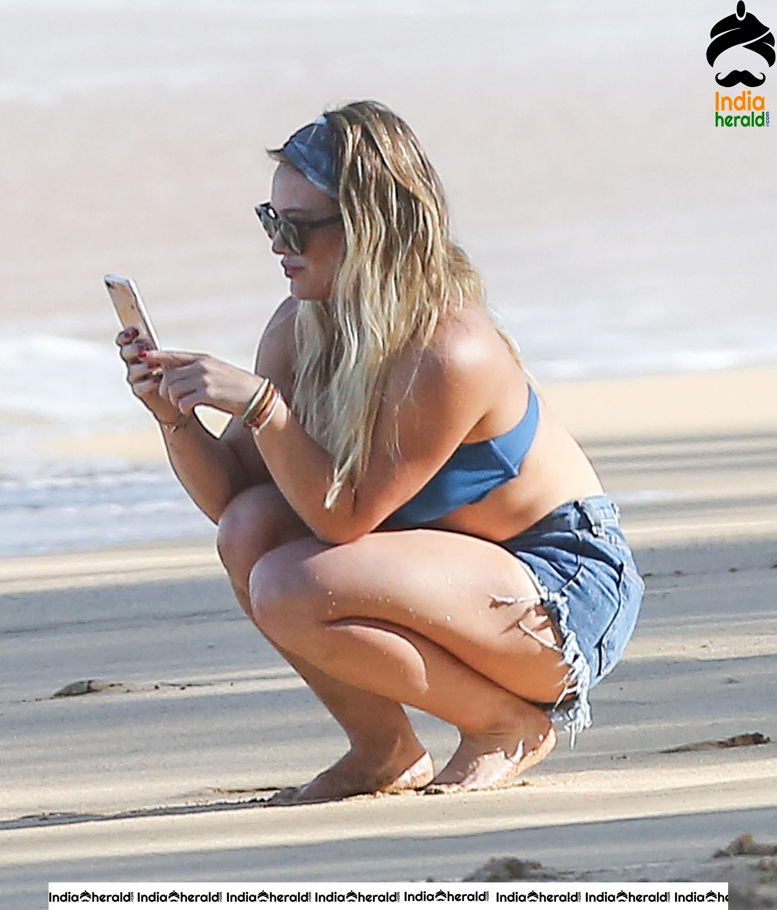 Hilary Duff Wearing a bikini top and shorts at the beach in Hawaii Set 2