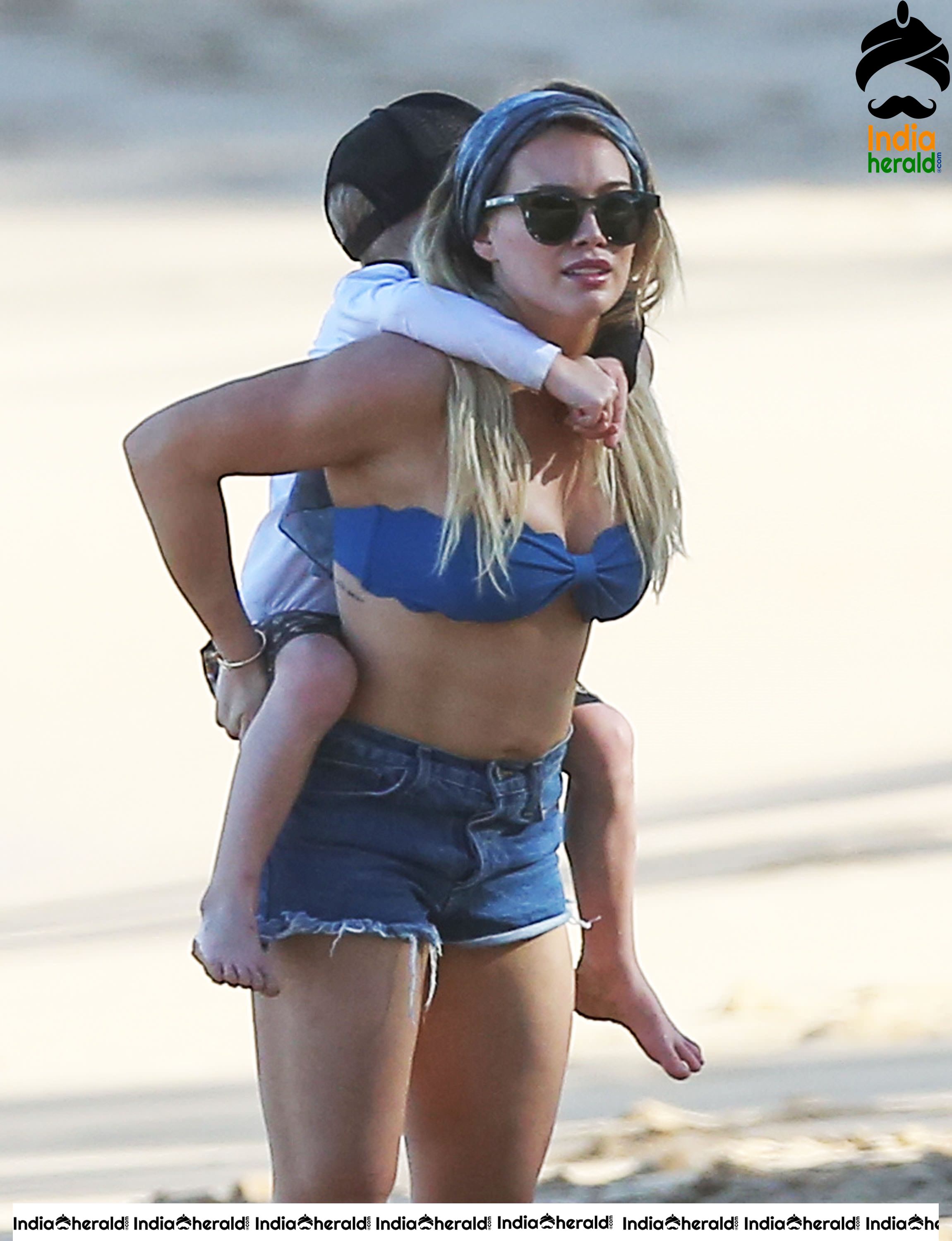 Hilary Duff Wearing a bikini top and shorts at the beach in Hawaii Set 2