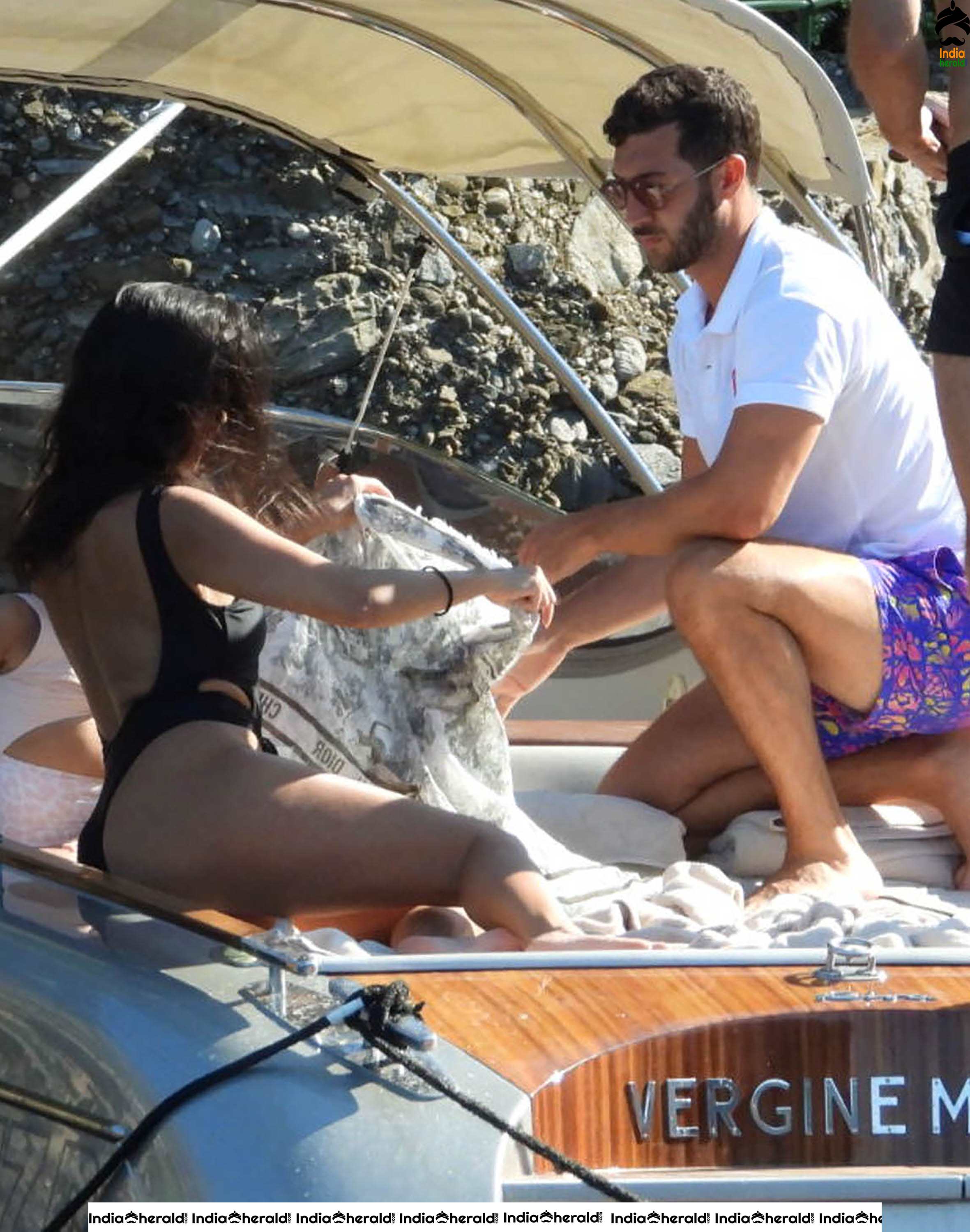 Kourtney Kardashian in a single piece bikini on a boat in Portofino