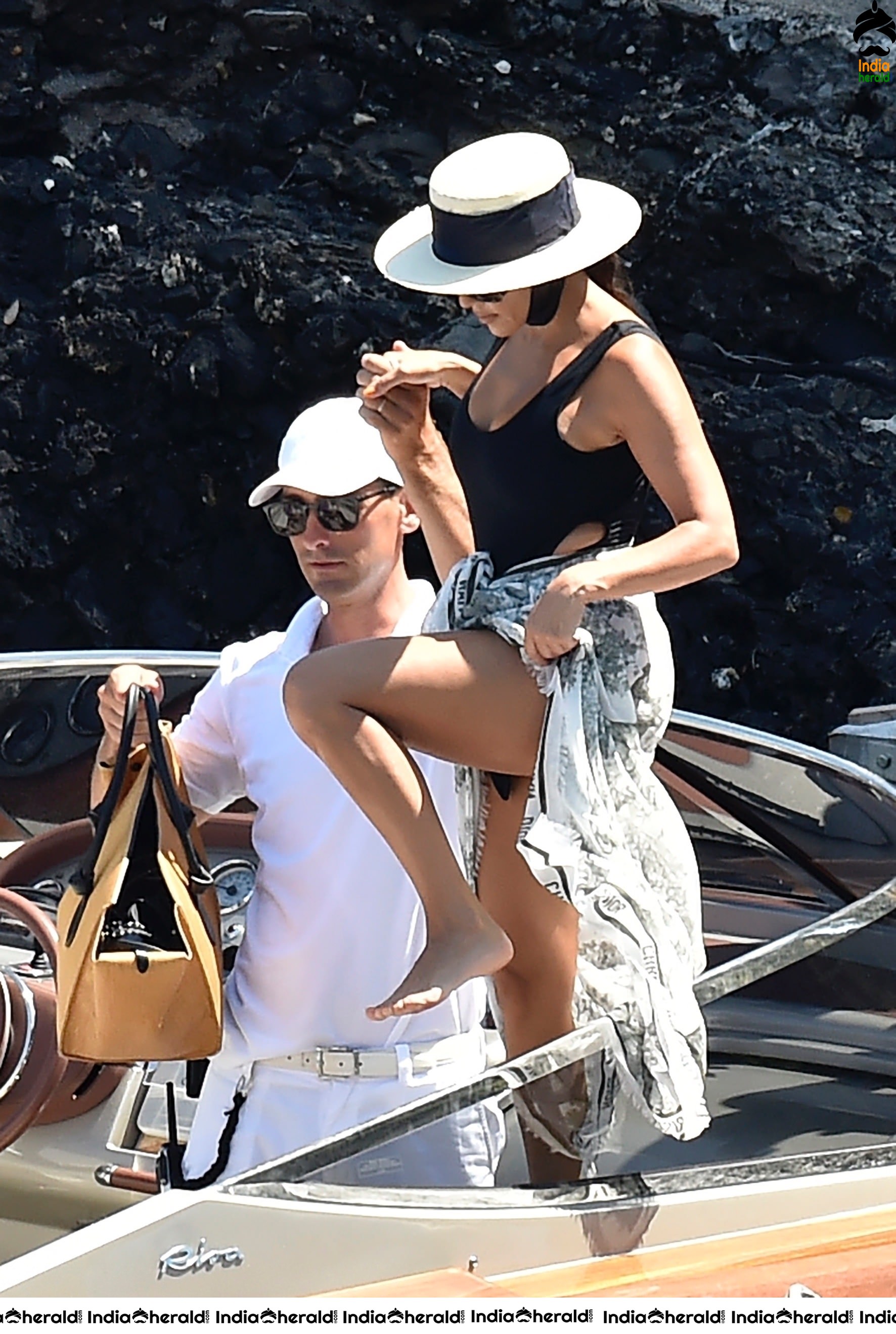 Kourtney Kardashian in a single piece bikini on a boat in Portofino