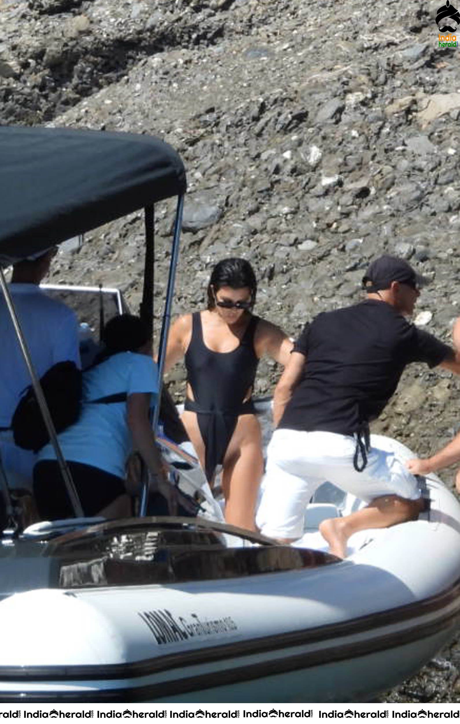 Kourtney Kardashian in a single piece bikini on a boat in Portofino