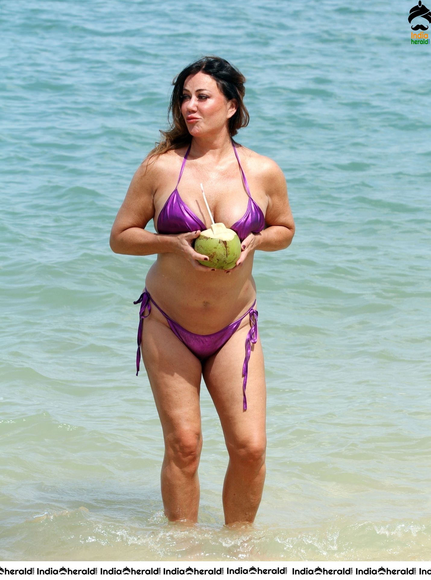 Lisa Appleton in a shiny purple bikini while on holiday in Thailand