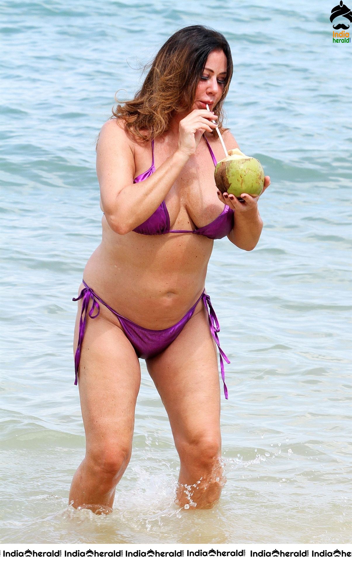 Lisa Appleton in a shiny purple bikini while on holiday in Thailand