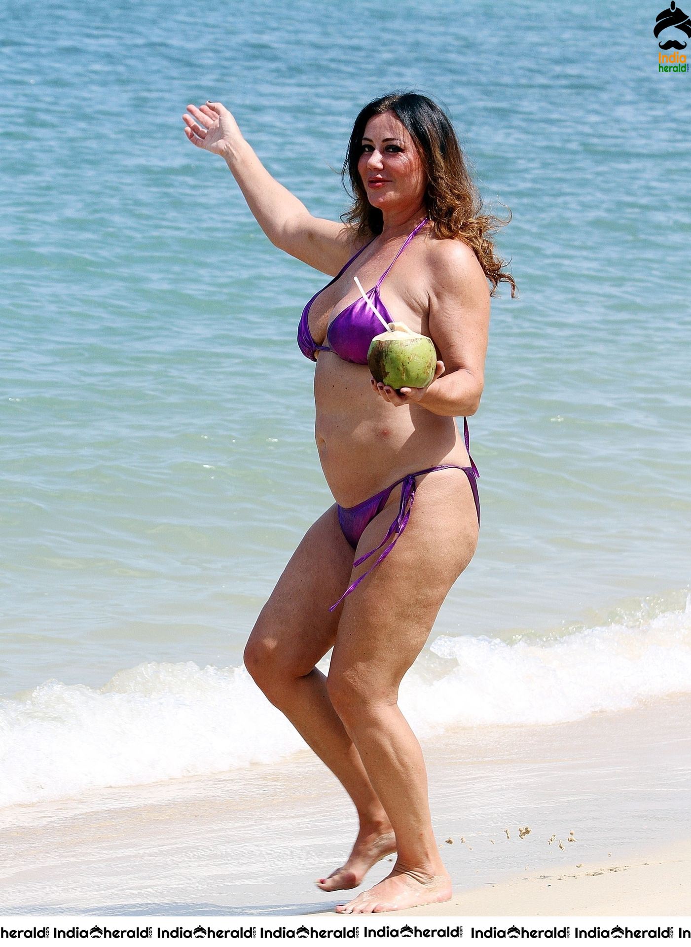 Lisa Appleton in a shiny purple bikini while on holiday in Thailand