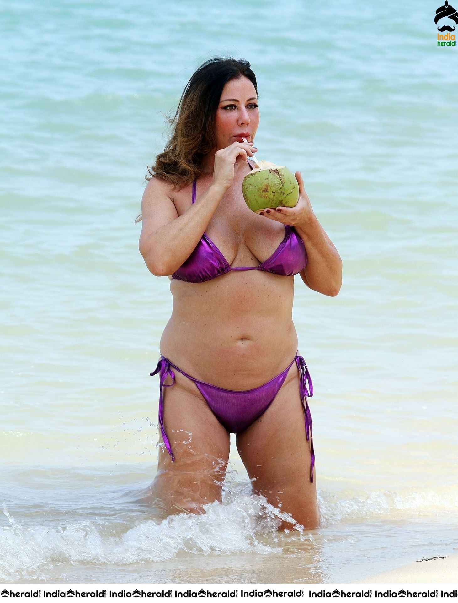 Lisa Appleton in a shiny purple bikini while on holiday in Thailand