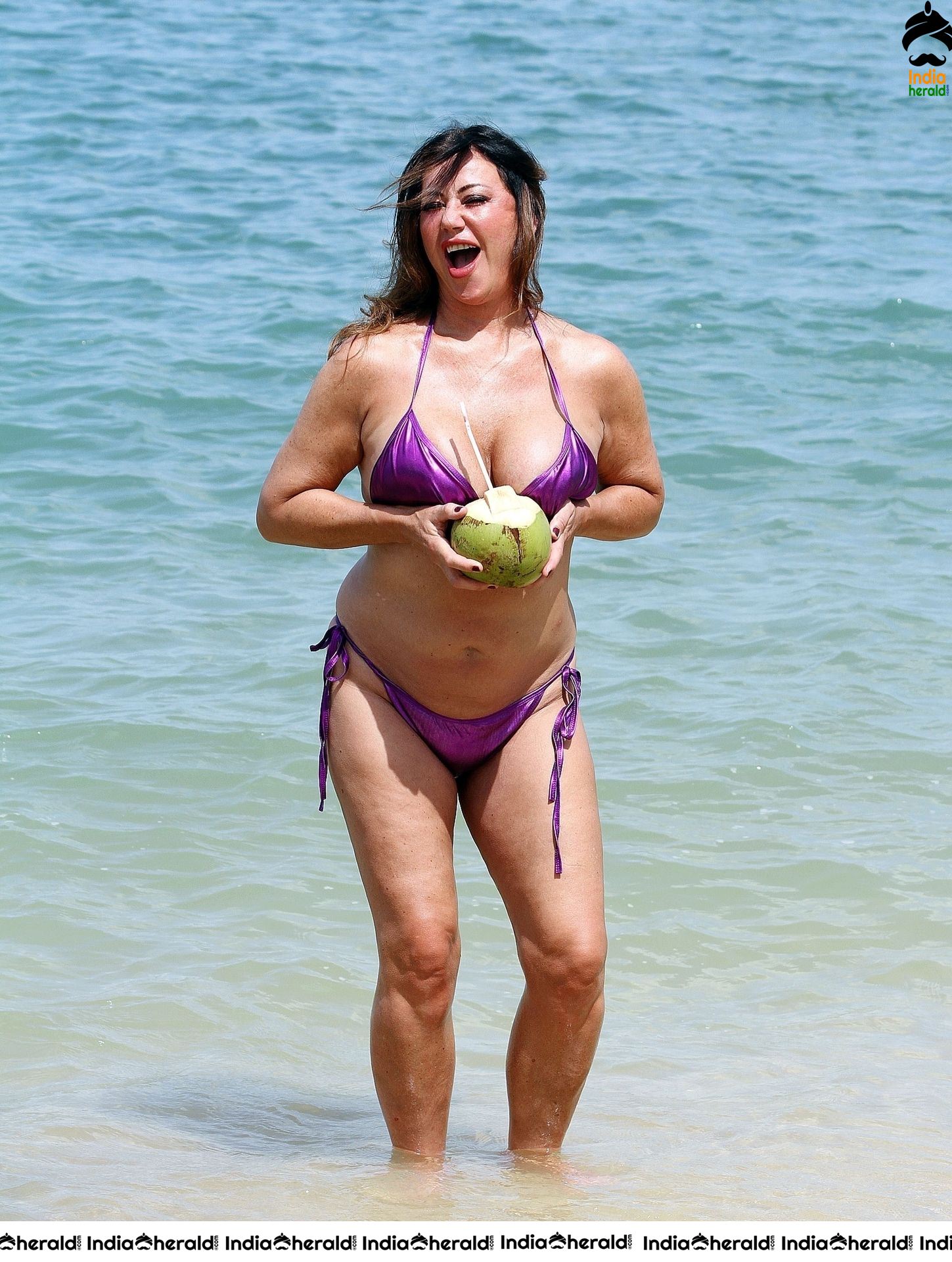 Lisa Appleton in a shiny purple bikini while on holiday in Thailand