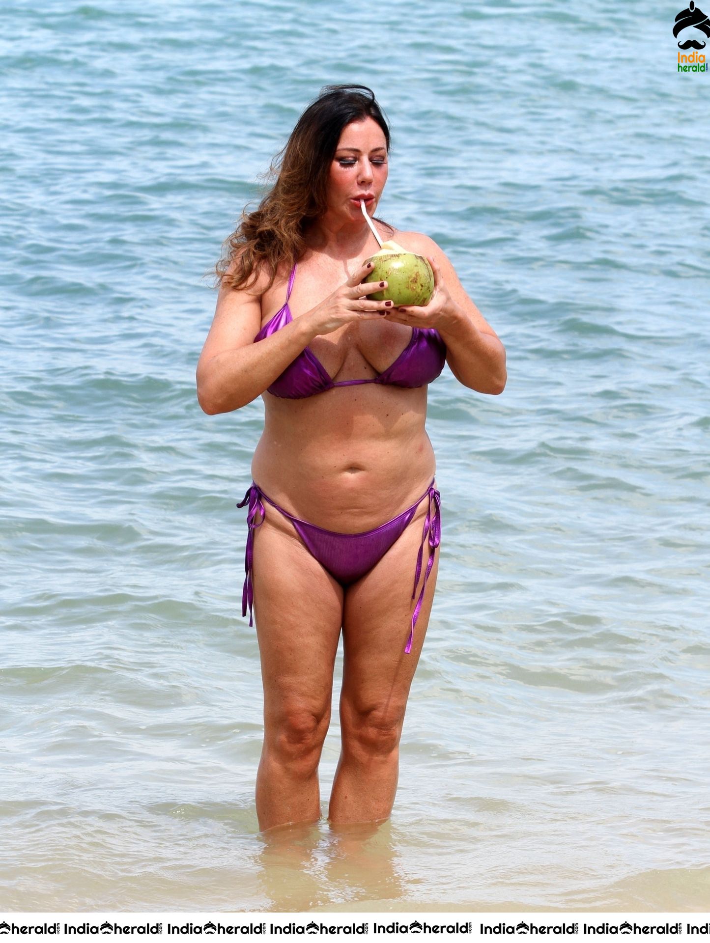 Lisa Appleton in a shiny purple bikini while on holiday in Thailand