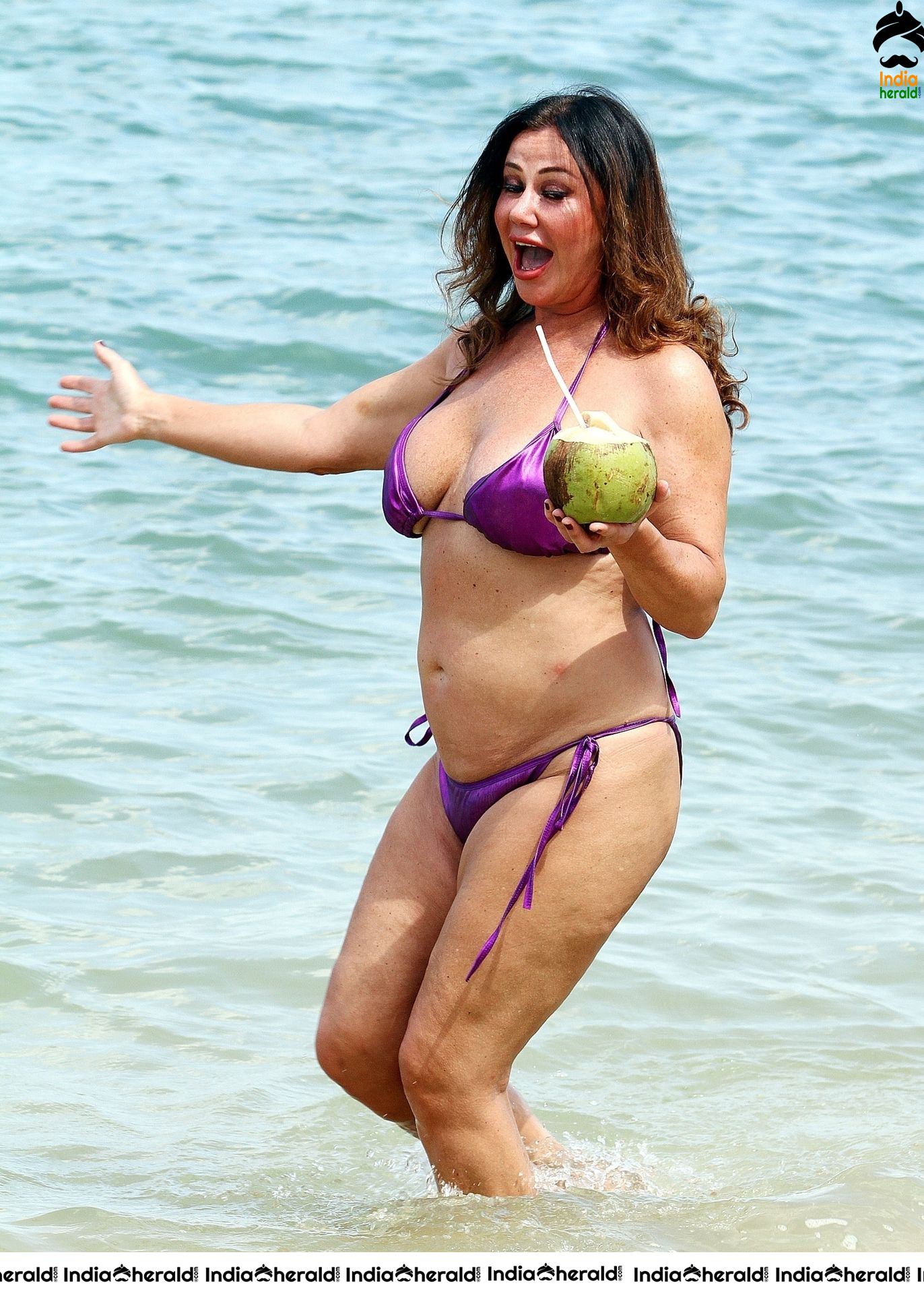 Lisa Appleton in a shiny purple bikini while on holiday in Thailand