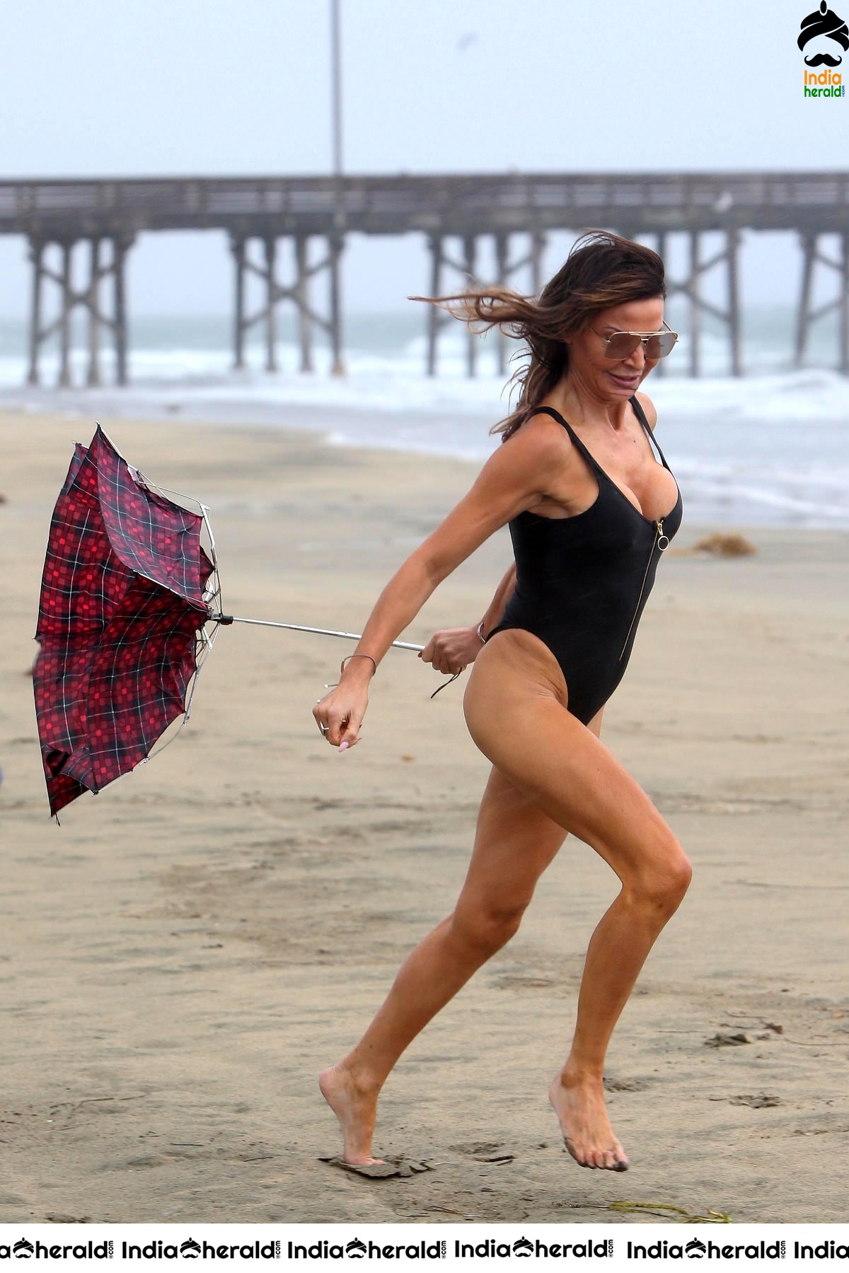 Lizzie Cundy in Bikini doesnt let a storm stop her hitting the beach in LA