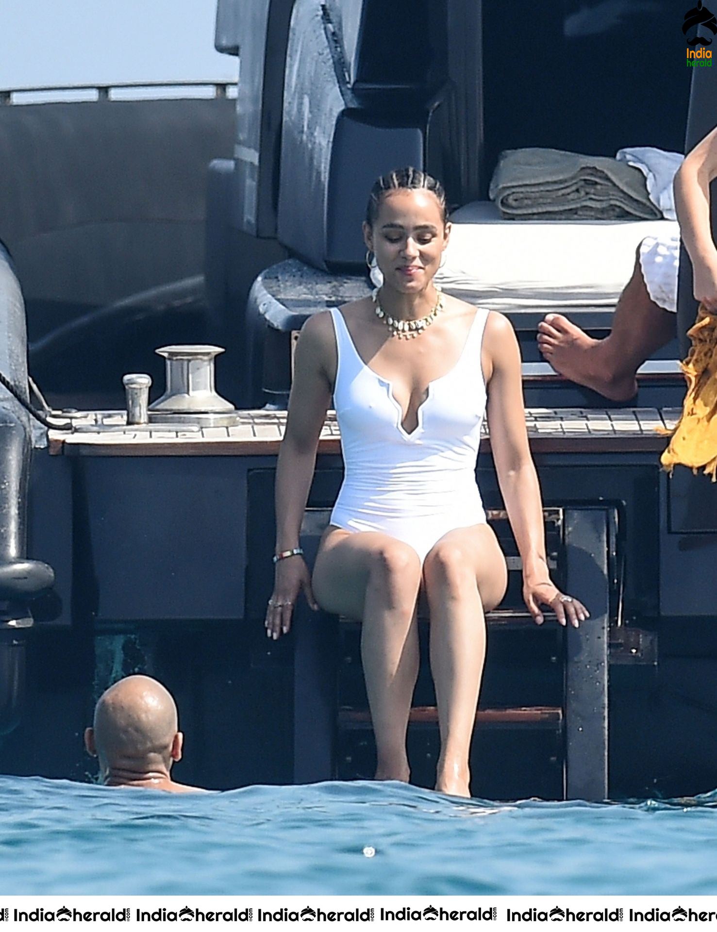 Nathalie Emmanuel wearing a white swimsuit while on vacation in Italy