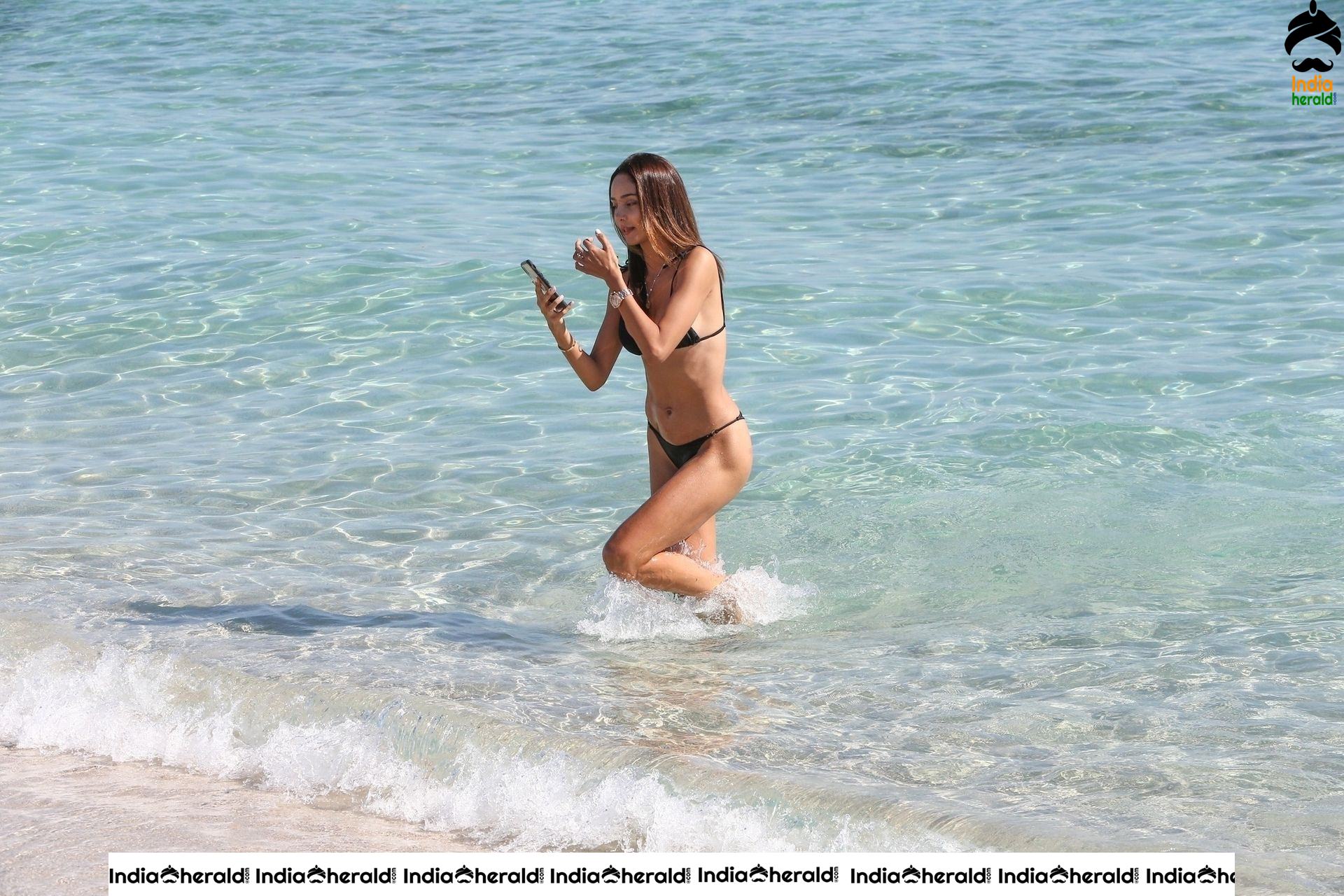 Patricia Contreras takes a quick dip in the water while at the beach in Miami