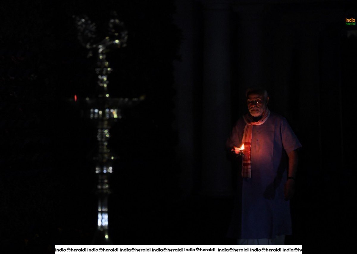 PM Modi lights a lamp after turning off all lights at his residence to mark India fighting against Corona Virus