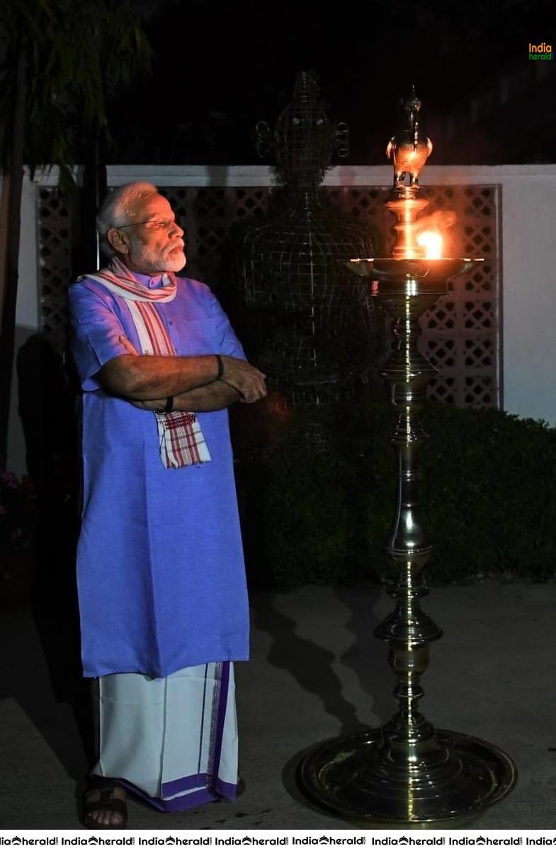 PM Modi lights a lamp after turning off all lights at his residence to mark India fighting against Corona Virus
