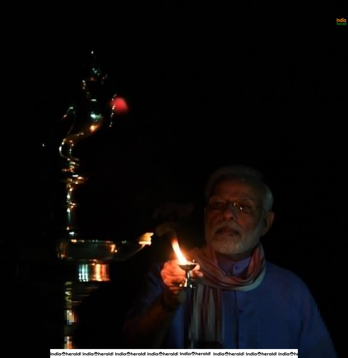 PM Modi lights a lamp after turning off all lights at his residence to mark India fighting against Corona Virus