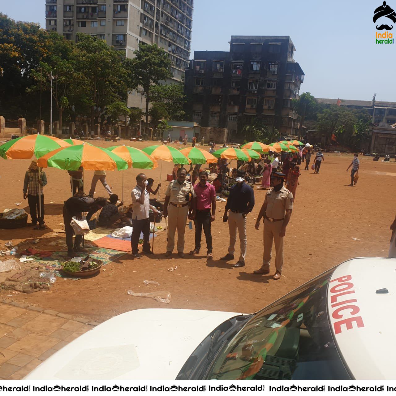 Police distributed umbrellas to vegetable vendors in open ground as a precaution against Corona Virus