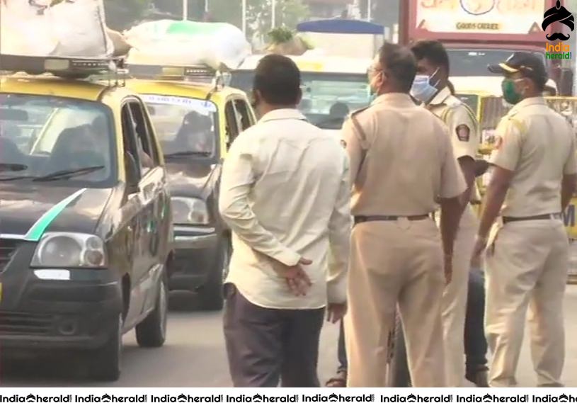 Security tightened as Police personnel in Mumbai check passes of vehicles during Corona Virus Lockdown