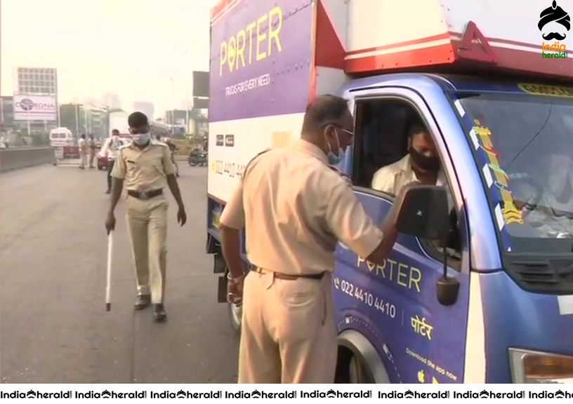 Security tightened as Police personnel in Mumbai check passes of vehicles during Corona Virus Lockdown