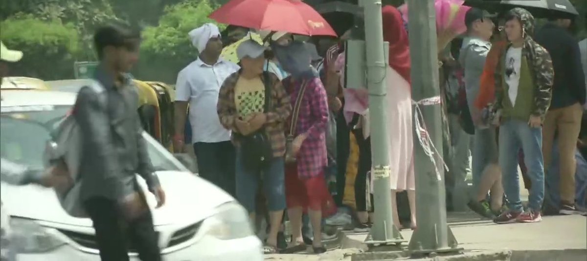 People Cover Their Heads As Mercury Touches 42 Degrees Celsius In Delhi