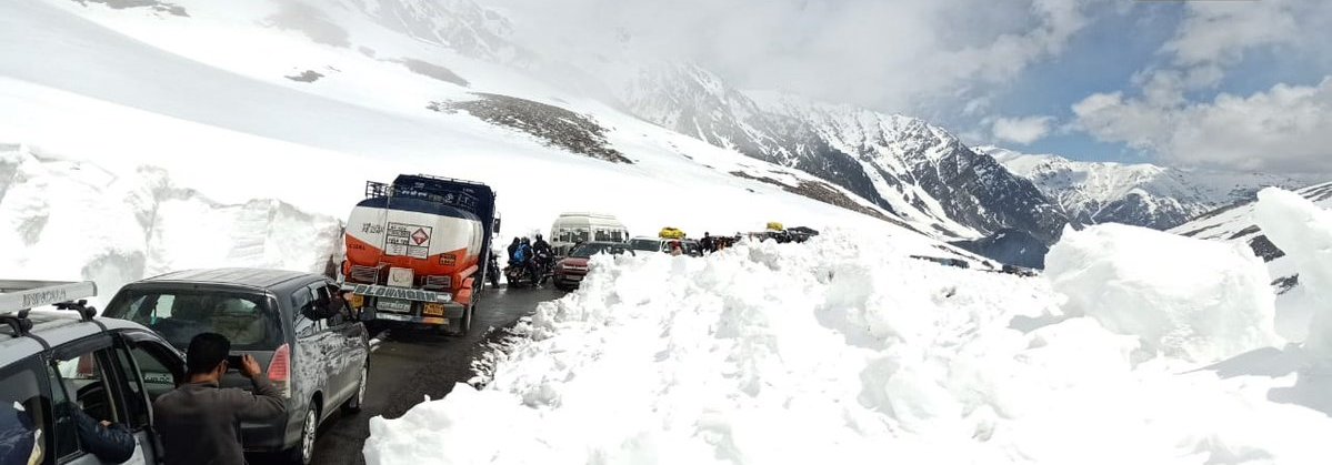 Vehicles Travel Amid Snow Clad Mountain At Bara Lacha La Mountain Pass