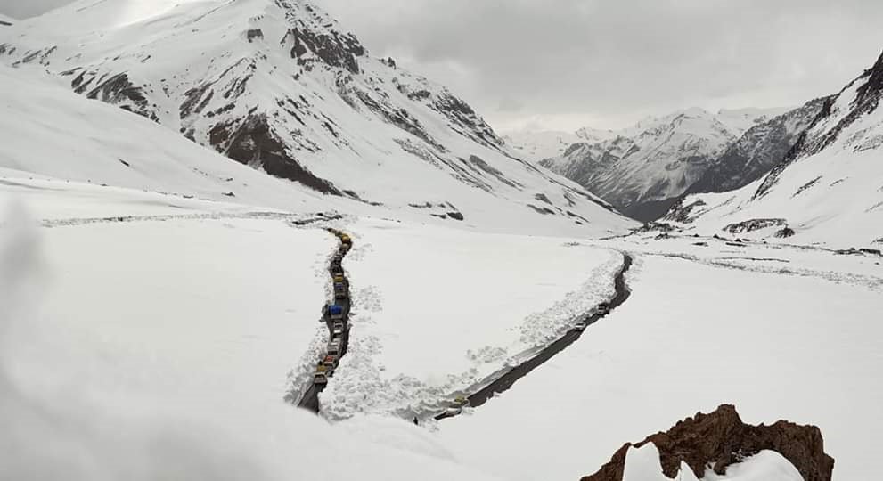 Vehicles Travel Amid Snow Clad Mountain At Bara Lacha La Mountain Pass