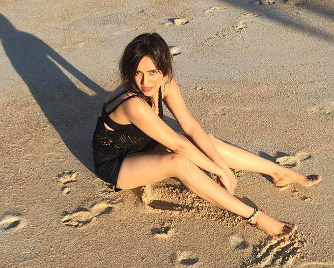 Neha Sharma Relaxing In Beach Photos