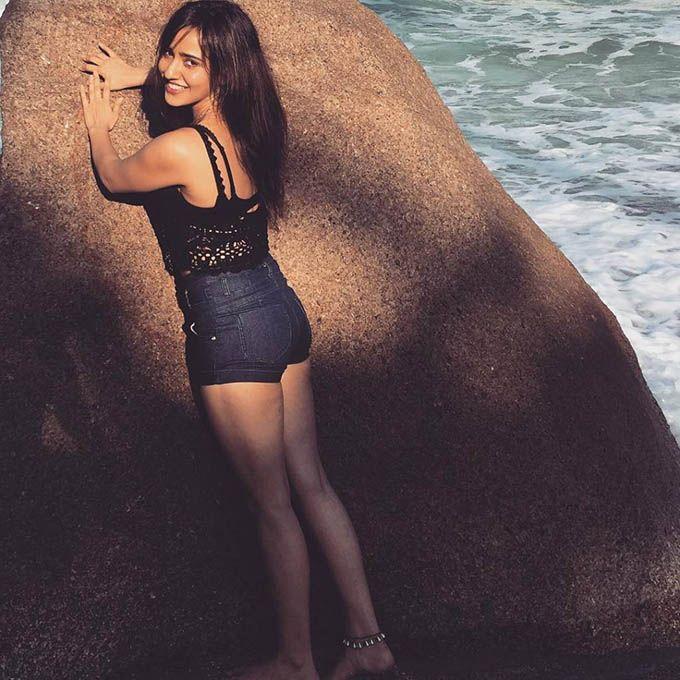 Neha Sharma Relaxing In Beach Photos