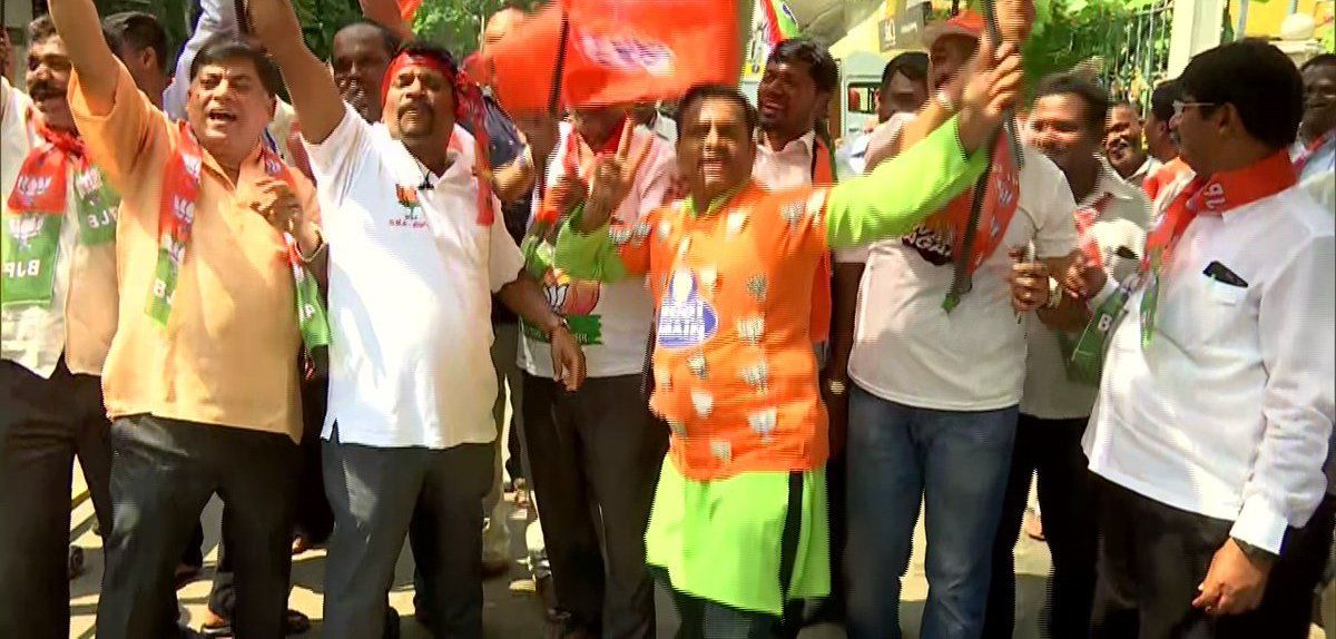 BJP members celebrate outside their HQ in Bengaluru