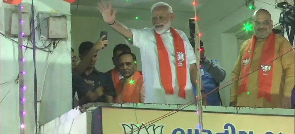 Modi waves at BJP supporters outside the party office in Ahmedabad