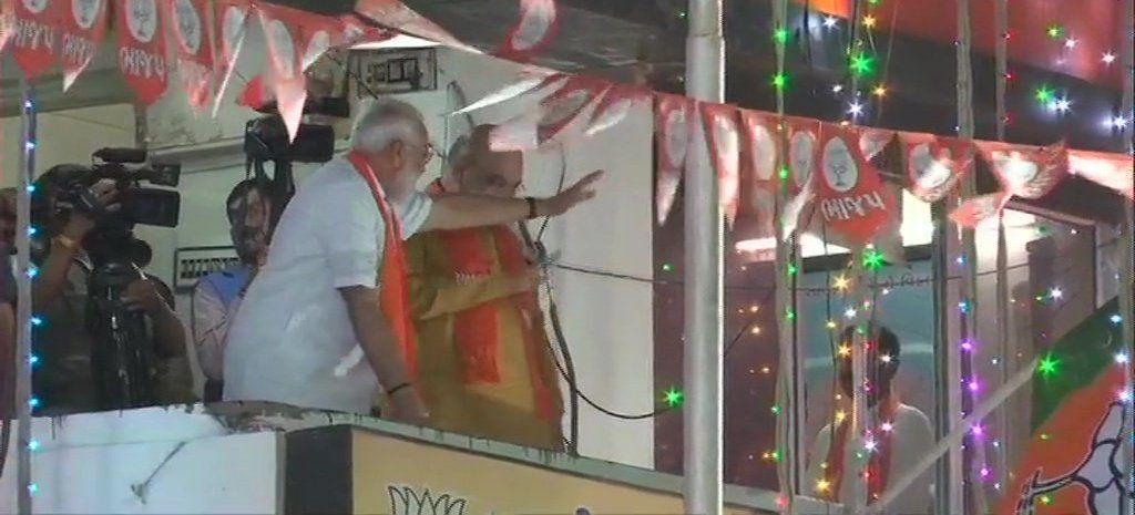 Modi waves at BJP supporters outside the party office in Ahmedabad