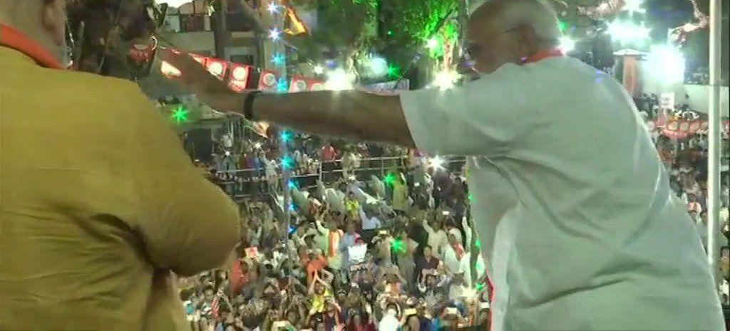 Modi waves at BJP supporters outside the party office in Ahmedabad