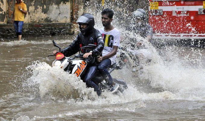 PHOTOS: Visuals of heavy rain & waterlogged streets from Mumbai's