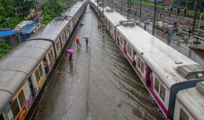 PHOTOS: Visuals of heavy rain & waterlogged streets from Mumbai's