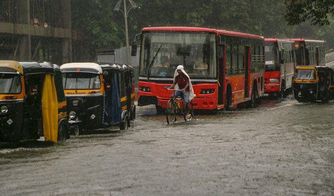 PHOTOS: Visuals of heavy rain & waterlogged streets from Mumbai's