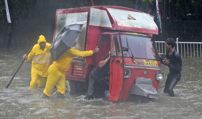 PHOTOS: Visuals of heavy rain & waterlogged streets from Mumbai's