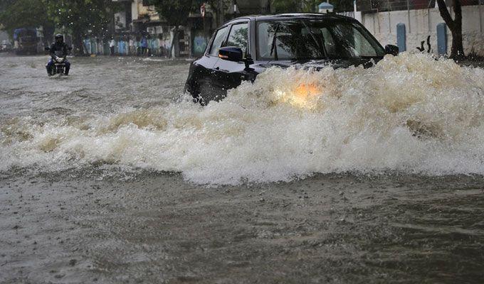 PHOTOS: Visuals of heavy rain & waterlogged streets from Mumbai's