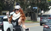 Phoebe Price shows off a new mask as she walks her dog in LA
