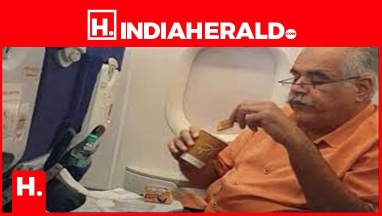 Indigo MD eating Parle-G with tea in flight