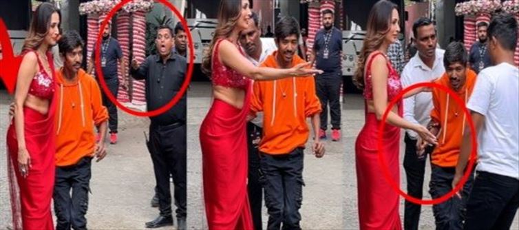 A fan holding Malaika Arora's waist in a public place..!?